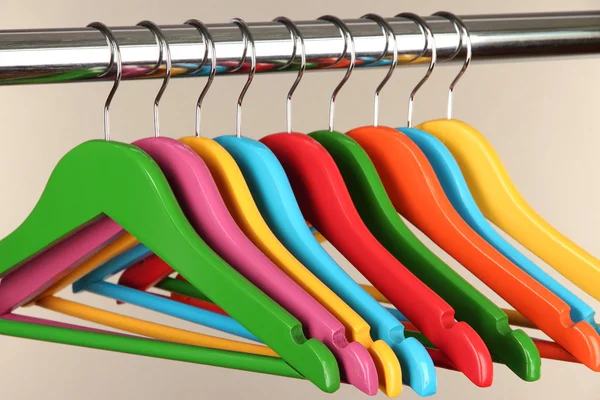 Colorful clothes hangers on gray background — Stock Photo, Image