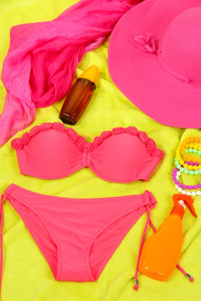 Swimsuit and beach items on bright background — Stock Photo, Image