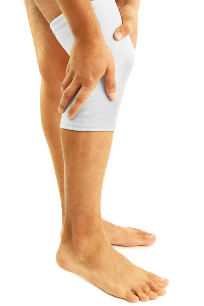 Young man with elastic bandage on knee, isolated on white — Stock Photo, Image