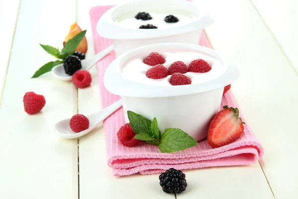 Delicious yogurt with fruit and berries on table close-up Stock Photo