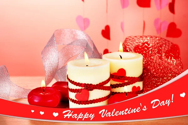 Candles for Valentine's Day on wooden table on red background — Stock Photo, Image