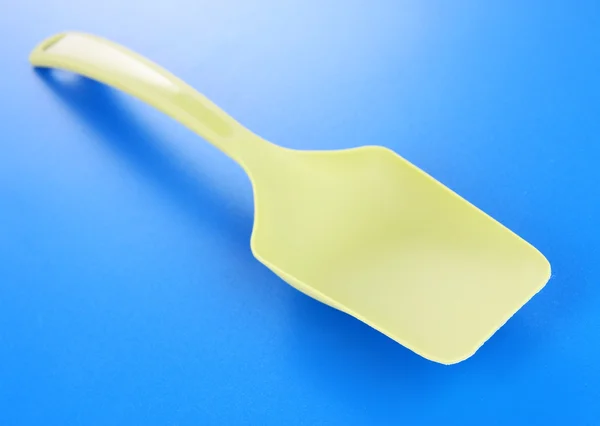 Plastic kitchen utensil on blue background — Stock Photo, Image