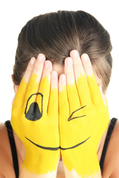 Retrato de menina escondendo seu rosto sob máscara de sorriso isolado no branco — Fotografia de Stock