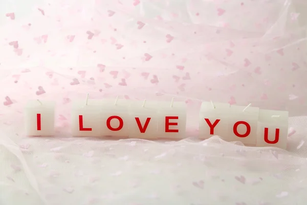 Candles with printed sign I LOVE YOU, on light background — стоковое фото