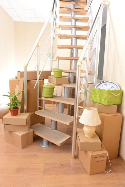 Stack of cartons near stairs: moving house concept — Stock Photo, Image