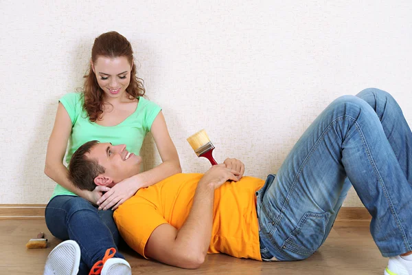 Young couple resting from renovation in new flat — Stock Photo, Image