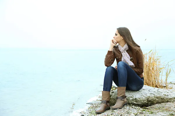 Portrait of young serious woman near river — Stock Photo, Image