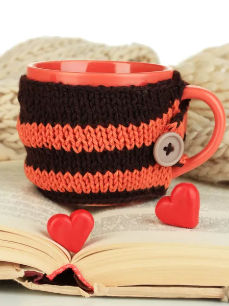 Cup with knitted thing on it and open book close up — Stock Photo, Image