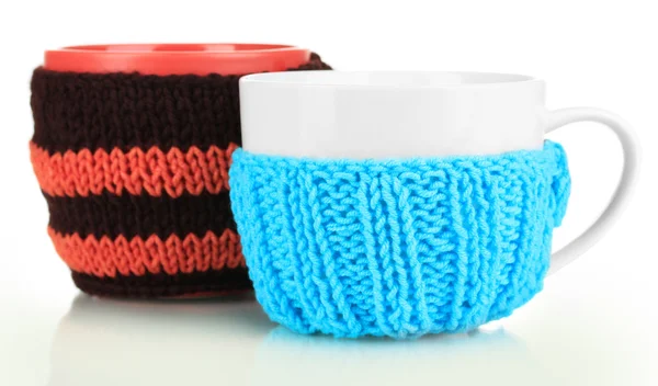 Cups with knitted things on it isolated on white — Stock Photo, Image