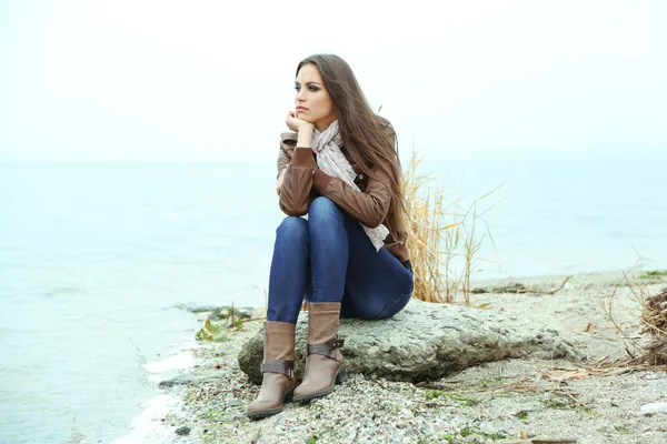 Portrait of young serious woman near river — Stock Photo, Image