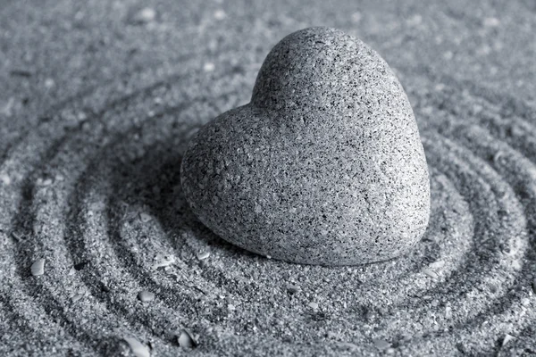 Gris piedra zen en forma de corazón, sobre fondo de arena —  Fotos de Stock