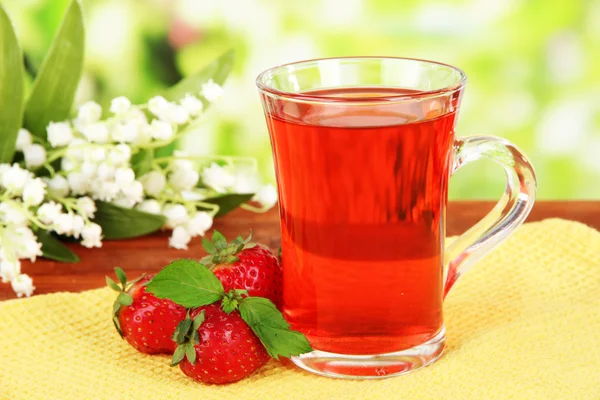 Delicioso té de fresa en la mesa sobre fondo brillante —  Fotos de Stock