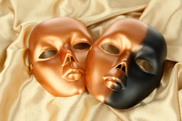 Mask on gold fabric background — Stock Photo, Image