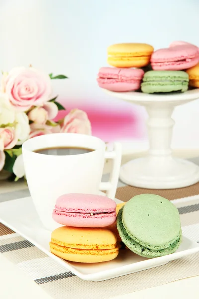 Coffee and macaroons on table on light background — Stock Photo, Image