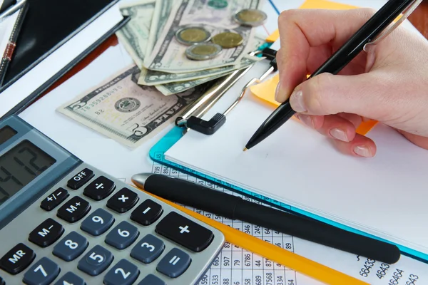 Woman hand with pen on worktable background — Stock Photo, Image