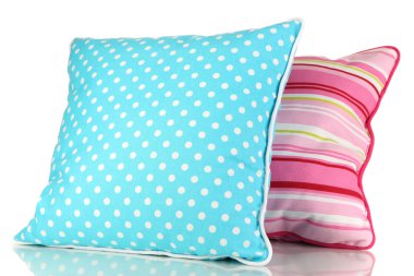 Mavi ve pembe parlak yastıklar beyaza izole edilmiş.