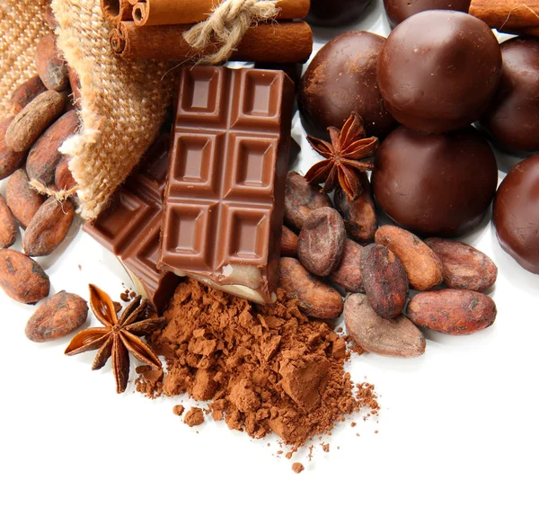 Composition of chocolate sweets, cocoa and spices, isolated on white — Stock Photo, Image