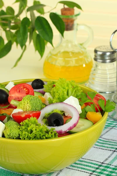 Greek salad on plate on table on light background — Stock Photo, Image