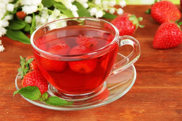 Delicious strawberry tea on table close-up — Stock Photo, Image