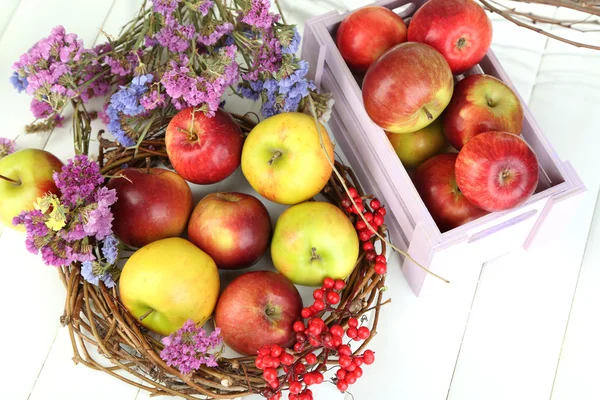 Juicy apples in box on white wooden table — Stock Photo, Image