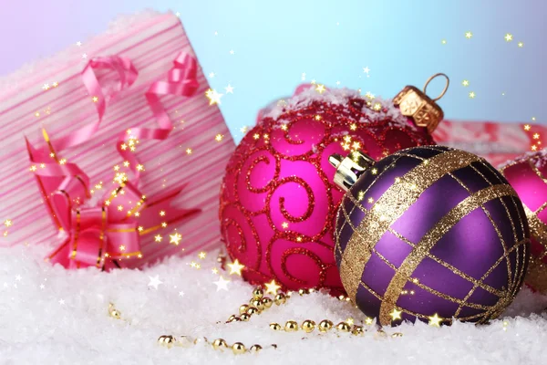 Beautiful Christmas balls and gifts on snow on bright background Telifsiz Stok Imajlar