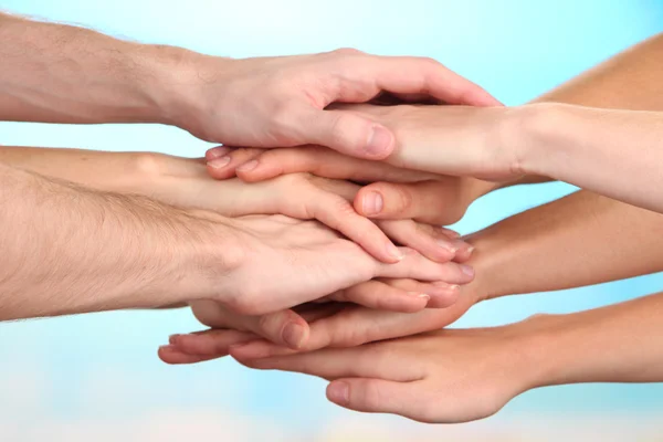 United hands on bright background. Conceptual photo of teamwork Royalty Free Stock Photos