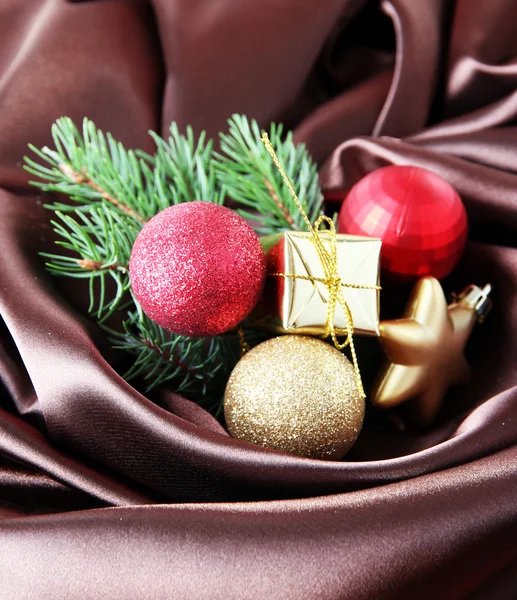 Beautiful Christmas decor on brown satin cloth — Stock Photo, Image