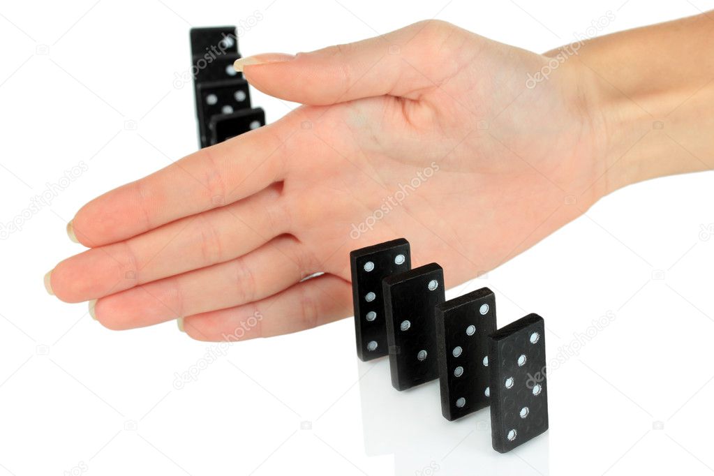 Hand stopping dominoes falling isolated on white