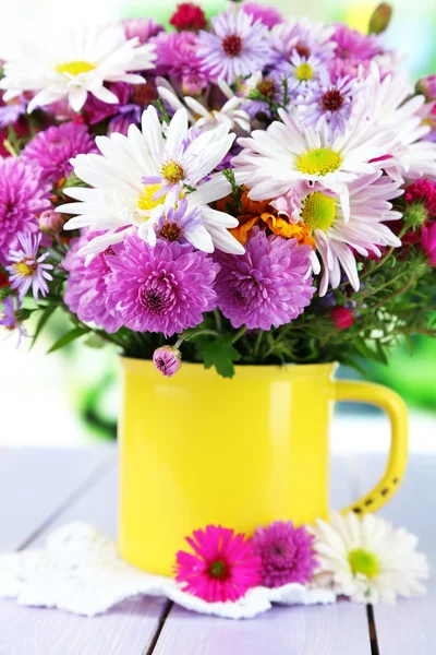 Wilde bloemen in mok op servet op houten tafel op achtergrond van venster — Stockfoto