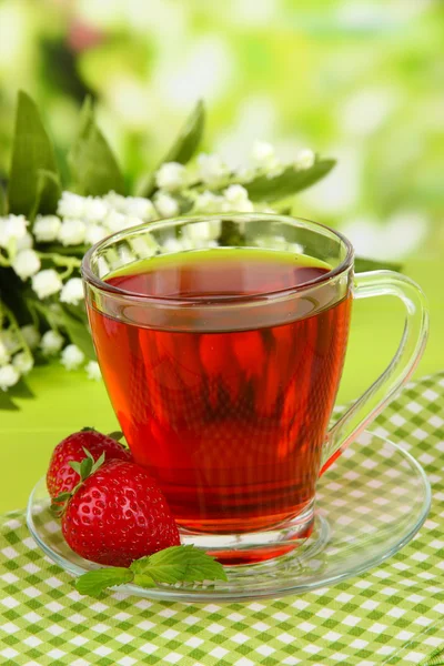 Delicious strawberry tea on table on bright background — Stock Photo, Image