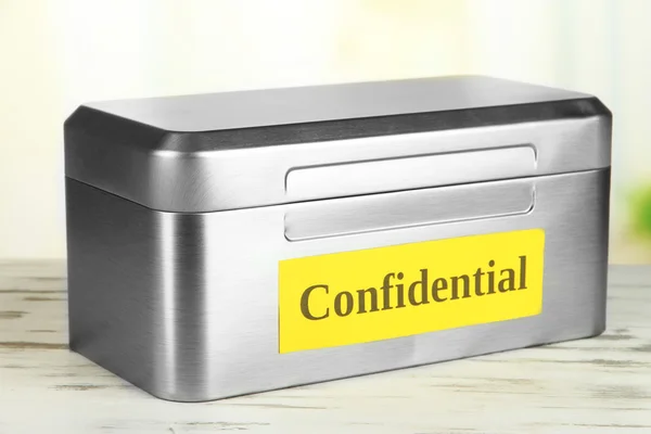 Confidential information in silvery box on bright background — Stock Photo, Image