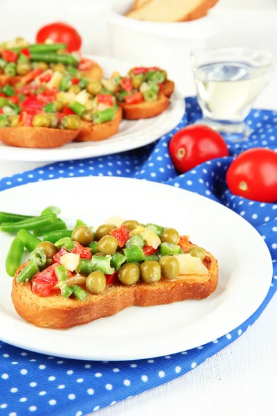 Sandwiches with vegetables and greens on plate on wooden table close-up — Stock Photo, Image