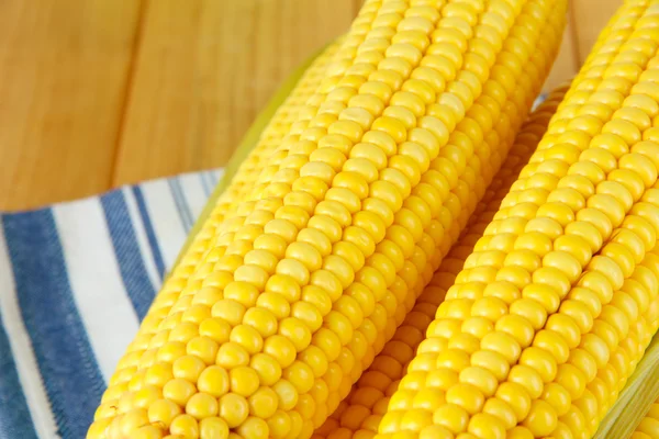 Crude corns on napkin on wooden table — Stock Photo, Image