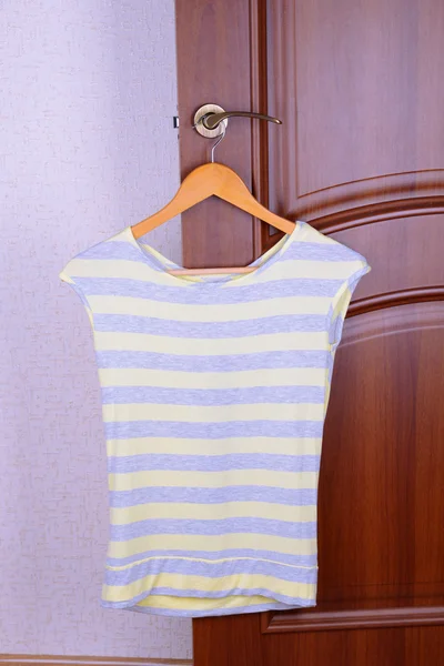 T-shirt hanging on door — Stock Photo, Image