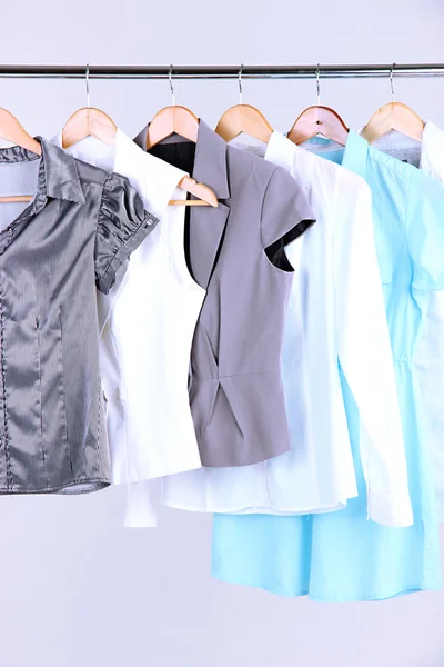 Office female clothes on hangers, on gray background — Stock Photo, Image