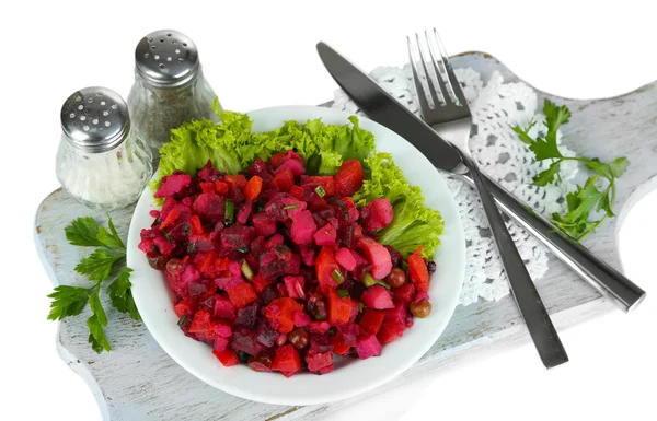 Beet salad on plate on napkin on wooden board isolated on white — Stock Photo, Image