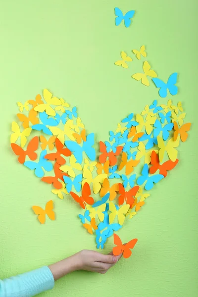 Paper butterflies on hand — Stock Photo, Image