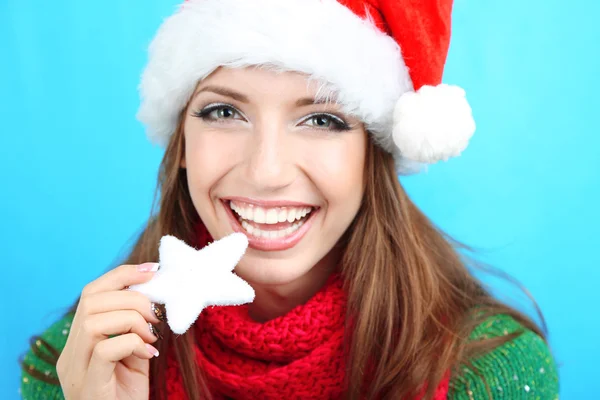 Bella ragazza sorridente con fiocco di neve di Natale su sfondo blu — Foto Stock