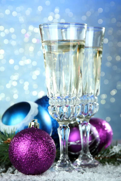 Composition with Christmas decorations and two champagne glasses, on bright background — Stock Photo, Image