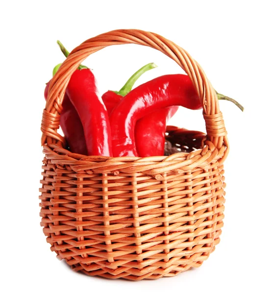 Red hot chili peppers in wicker basket,on sackcloth, isolated on white — Stock Photo, Image