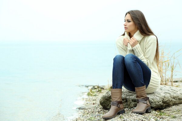 Young serious woman near river