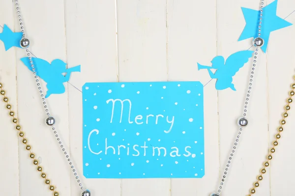 Bord met woorden vrolijk kerstfeest op houten tafel achtergrond close-up — Stockfoto