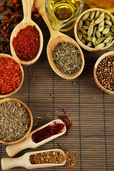 Many different spices and fragrant herbs on wooden table close-up