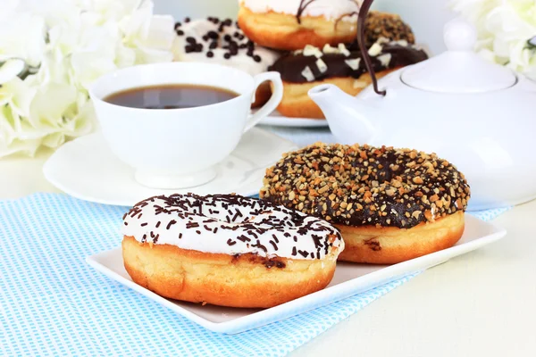 Ciambelle dolci con tazza di tè in tavola primo piano — Foto Stock