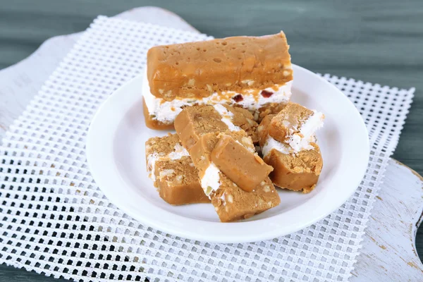 Sherbet with nuts on plate on wooden table close-up — Stock Photo, Image