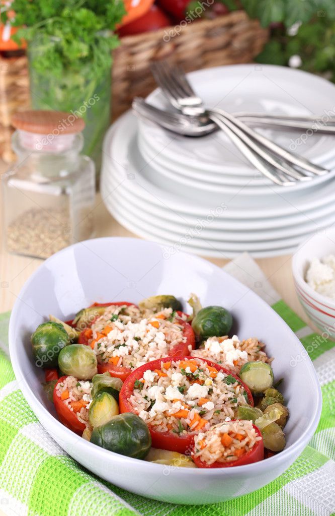 Stuffed tomatoes in bowl on wooden table close-up