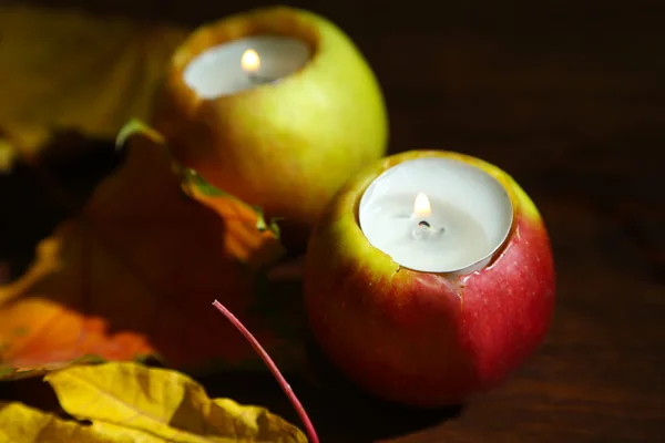 Composition with apples and candles on wooden background — Stock Photo, Image