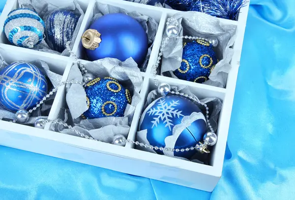 Christmas toys in wooden box on bright background — Stock Photo, Image