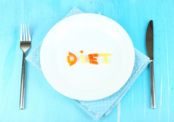 Small portion of food on big plate on wooden table close-up — Stock Photo, Image