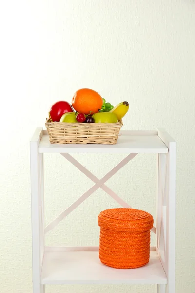 Fruit on white shelf on grey wall background — Stock Photo, Image